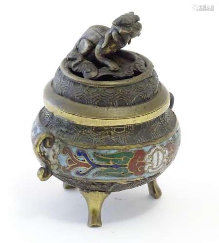 A Chinese cast brass three footed lidded censer, the body wi...
