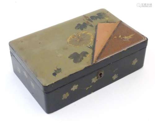A Japanese lacquered box with hinge lid decorated with flowe...