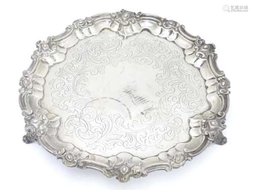 A Victorian silver salver with engraved decoration and on th...
