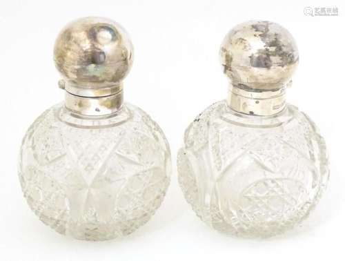 A pair of cut glass scent / perfume bottles of spherical for...