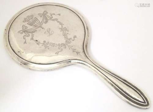 A silver hand mirror with engraved bow and swag detail hallm...