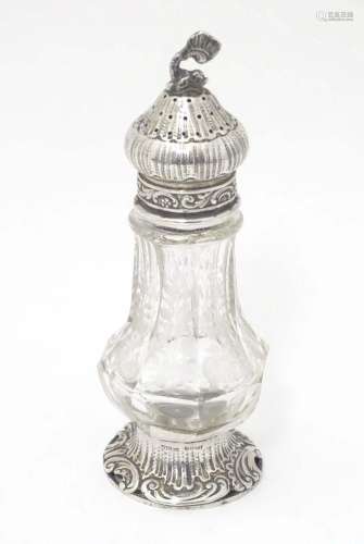 A Continental cut glass pepper pot engraved floral and folia...