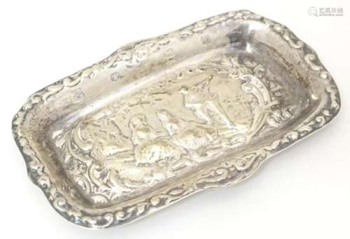 A silver pin dish with embossed decoration hallmarked Sheffi...