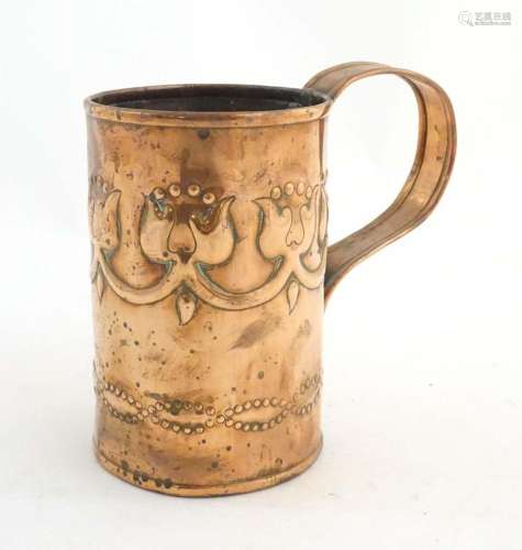 An Art Nouveau copper tankard with loop handle, decorated wi...