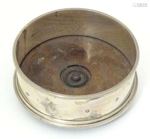 A small silver coaster with turned wooden base, hallmarked L...