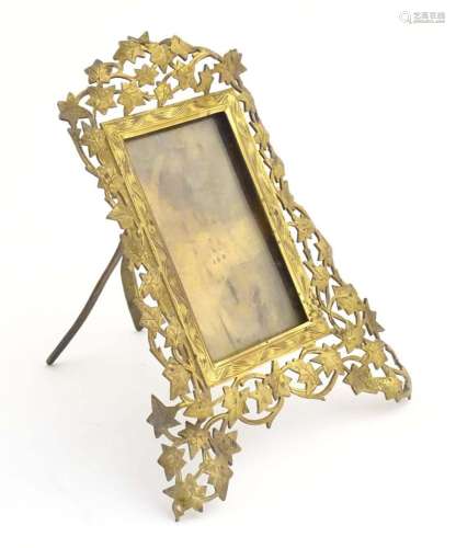 A Victorian brass easel back photograph frame, the surround ...