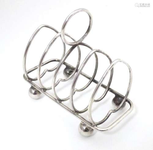 A silver five bar toast rack of heart form, hallmarked Sheff...