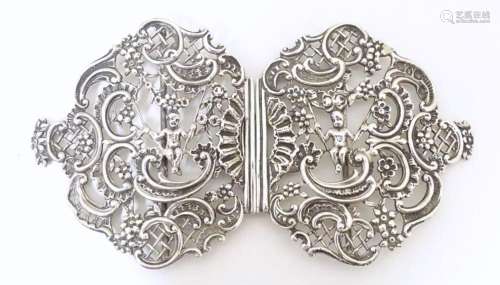 A Victorian silver two part belt buckle with putti and C scr...