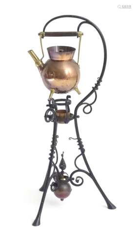 An Arts & Crafts copper and brass spirit kettle on a scr...