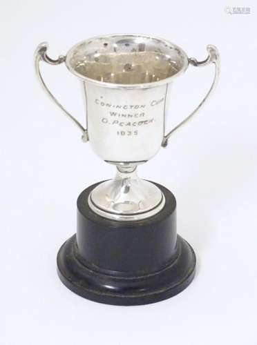 An Art Deco miniature silver twin handled trophy cup with so...