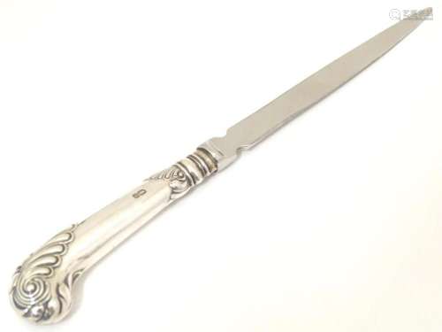 A letter opener with silver pistol grip handle hallmarked Sh...