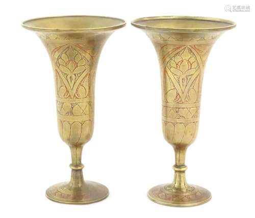 A pair of brass pedestal vases of fluted form with stylised ...