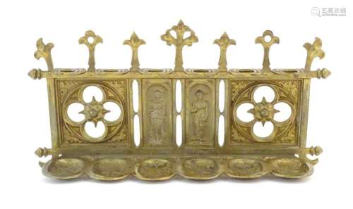An early 20thC cast brass pipe rack with provision for 6 pip...