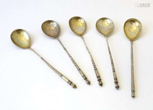 Five Russian silver gilt spoons with engraved decoration to ...