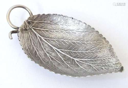A white metal caddy spoon modelled as a leaf. Approx. 2 1/2&...