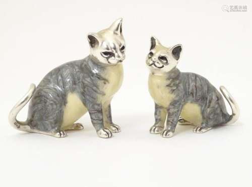 Two silver models of seated cats with enamel decoration. Mar...