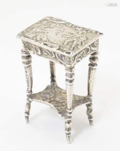 A silver miniature model of a table / dolls house table. Wit...