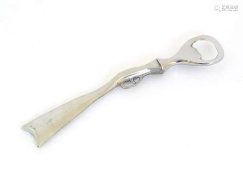 A boxed silver plated bottle opener, the handle formed as a ...