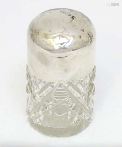 A cut glass scent / salts jar with silver top hallmarked Bir...