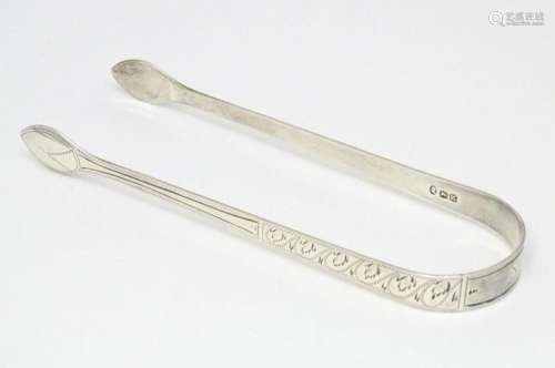 Geo III silver tongs with bright cut decoration hallmarked L...