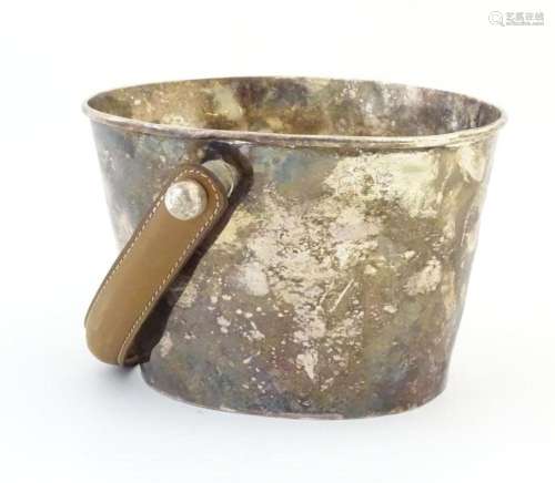 A silver plated champagne / wine ice bucket with leather han...