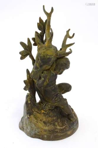 A 19thC cast brass model of a cherub / putto carrying a stag...