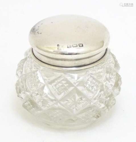 A cut glass dressing table pot with silver lid hallmarked Bi...