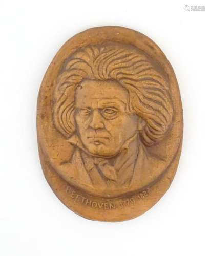 A 20thC terracotta oval plaque depicting a relief portrait o...