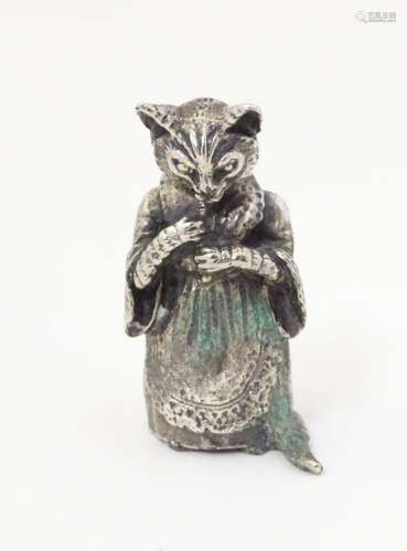 A white metal model of a Beatrix Potter style cat. Approx. 1...