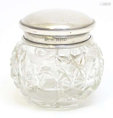A cut glass dressing table pot with silver top hallmarked Bi...