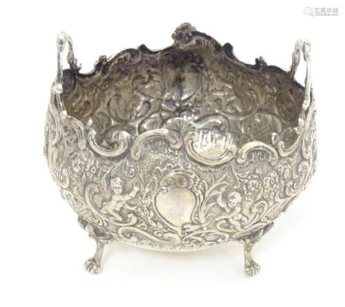 A Continental white metal twin handled bowl with embossed fl...
