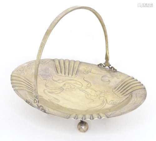 A Russian silver cake basket with swing handle and engraved ...