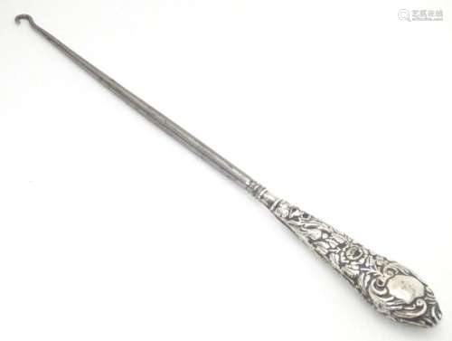 A button hook with embossed silver handle, hallmarked Birmin...