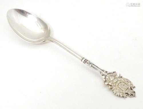 A silver teaspoon the handle surmounted by crest for London ...