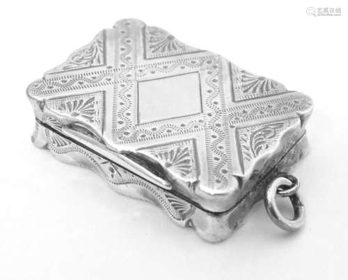 A Victorian silver vinaigrette with engraved decoration open...