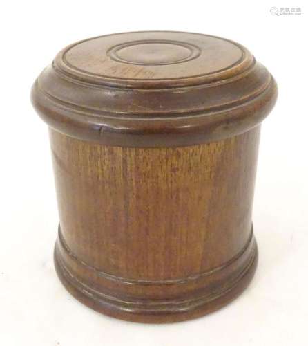 An early 20thC turned mahogany treen box and cover / contain...