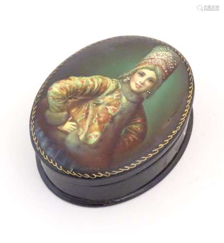 A 20thC Russian lacquered snuff box of oval form, the hinged...
