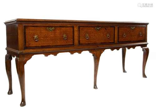 A George II oak and mahogany crossbanded dresser base, Engli...