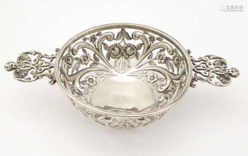 A Victorian silver bonbon dish modelled as a quaich with pie...