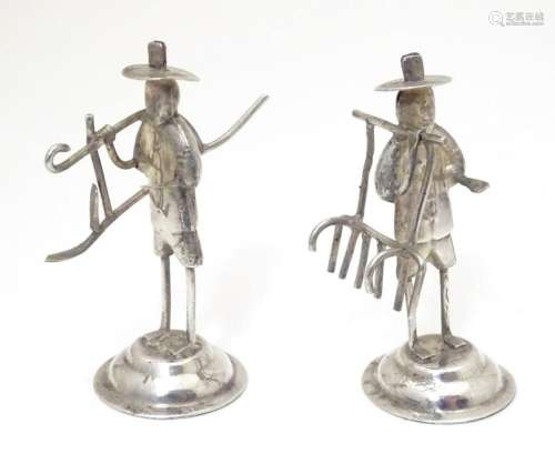 Chinese Export : A pair of white metal oriental figures mode...