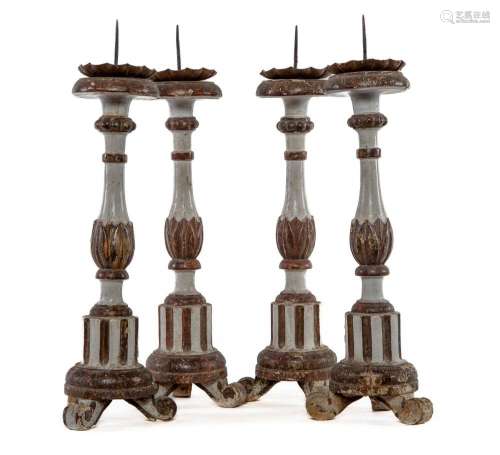 A set of four painted and gilt-gesso candlesticks, Italian c...