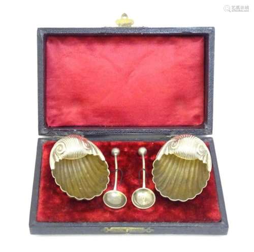 A cased pair of silver plate salts of shell form, bearing re...