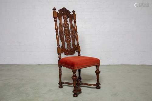 A well carved walnut high back chair in the William and Mary...