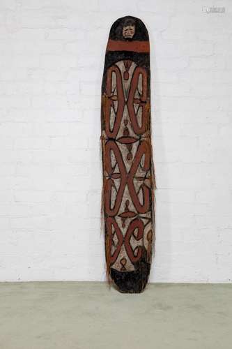 A tall Asmat war shield,Papua New Guinea,20th century