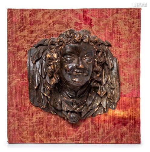 A pair of powerfully and expressively carved wood heads of a...