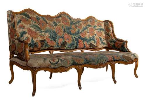 A large and impressive Louis XV period carved beech and tape...