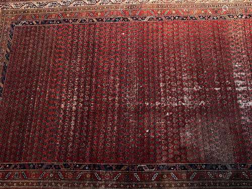 A Persian wool-pile red ground vestibule rug, early 20th cen...