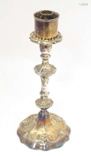A silver plate candlestick with acanthus scroll detail. Appr...