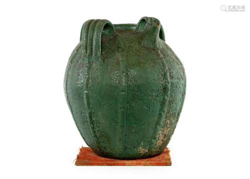 An unusual green glazed three handled terracotta pouring ves...