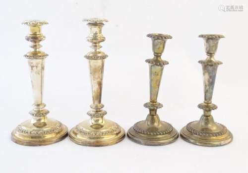 A pair of silver plate candlesticks. Together with another p...